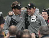 FILE - Europe's Ian Poulter, left, and Padraig Harrington react during a practice round at the 2010 Ryder Cup golf tournament in Newport, Wales, in this Tuesday, Sept. 28, 2010, file photo. Poulter comes into the seventh Ryder Cup of his career ranked 50th, the worst standing of any of the 24 players who will tee it up beginning Friday, Sept. 24, 2021. But there was never a hint of doubt that Padraig Harrington would use one of his captain's picks to make sure the 45-year-old Englishman, an avid Arsenal fan who is also a sports car collector, would be on the team. (AP Photo/Matt Dunham, File)