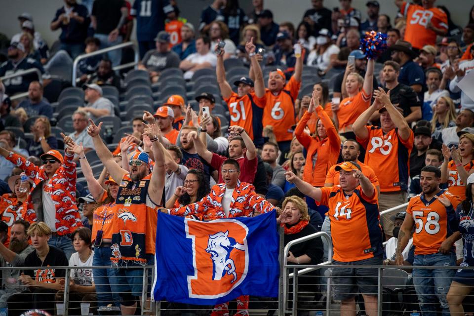 Denver Broncos fans celebrate during the second half against the Dallas Cowboys at AT&T Stadium.