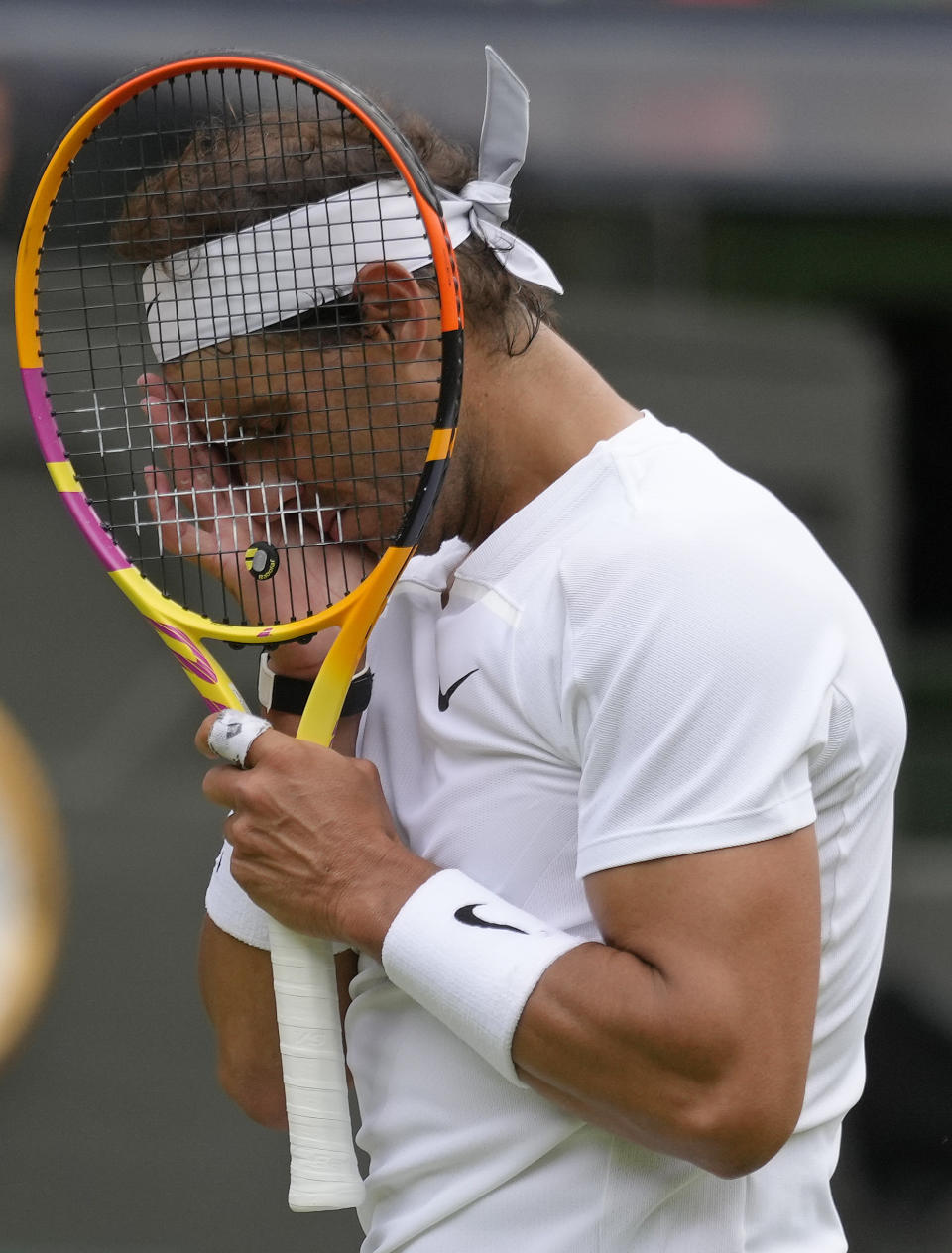 Spain's Rafael Nadal reacts after losing a point as he plays Taylor Fritz of the US in a men's singles quarterfinal match on day ten of the Wimbledon tennis championships in London, Wednesday, July 6, 2022. (AP Photo/Kirsty Wigglesworth)