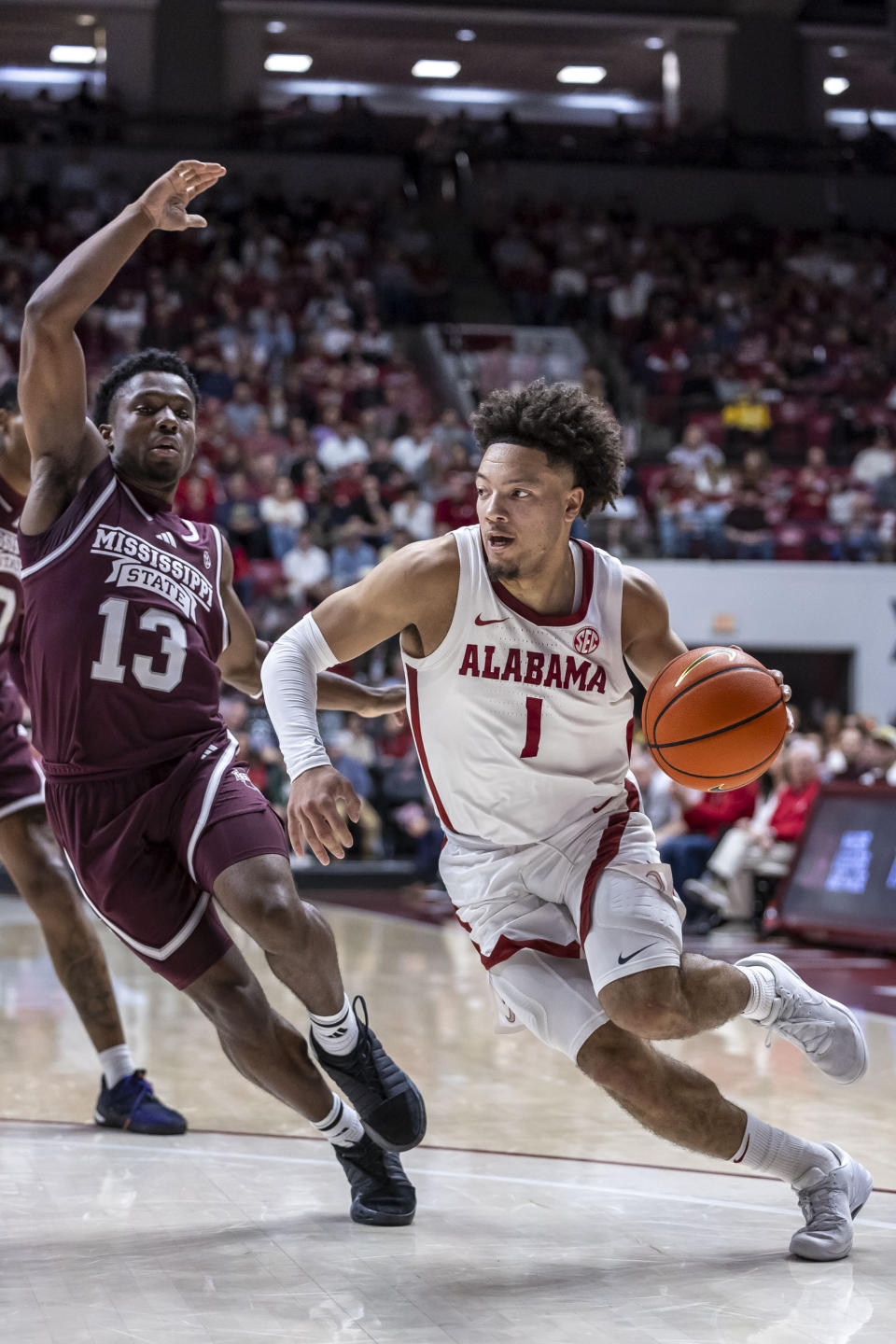 Alabama guard Mark Sears (1) penetrates past Mississippi State guard Josh Hubbard (13) during the first half of an NCAA college basketball game, Saturday, Feb. 3, 2024, in Tuscaloosa, Ala. (AP Photo/Vasha Hunt)