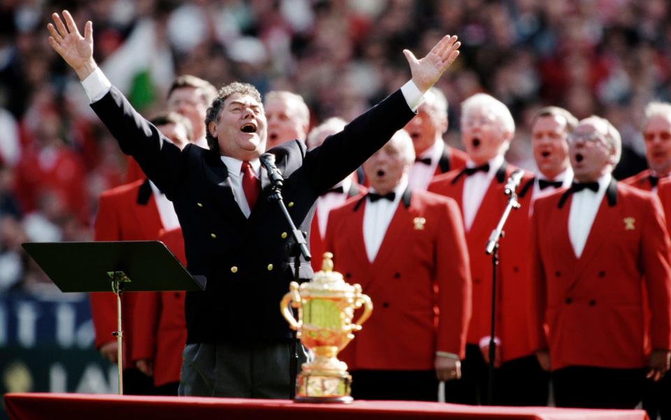 Max Boyce singing with a choir before the match