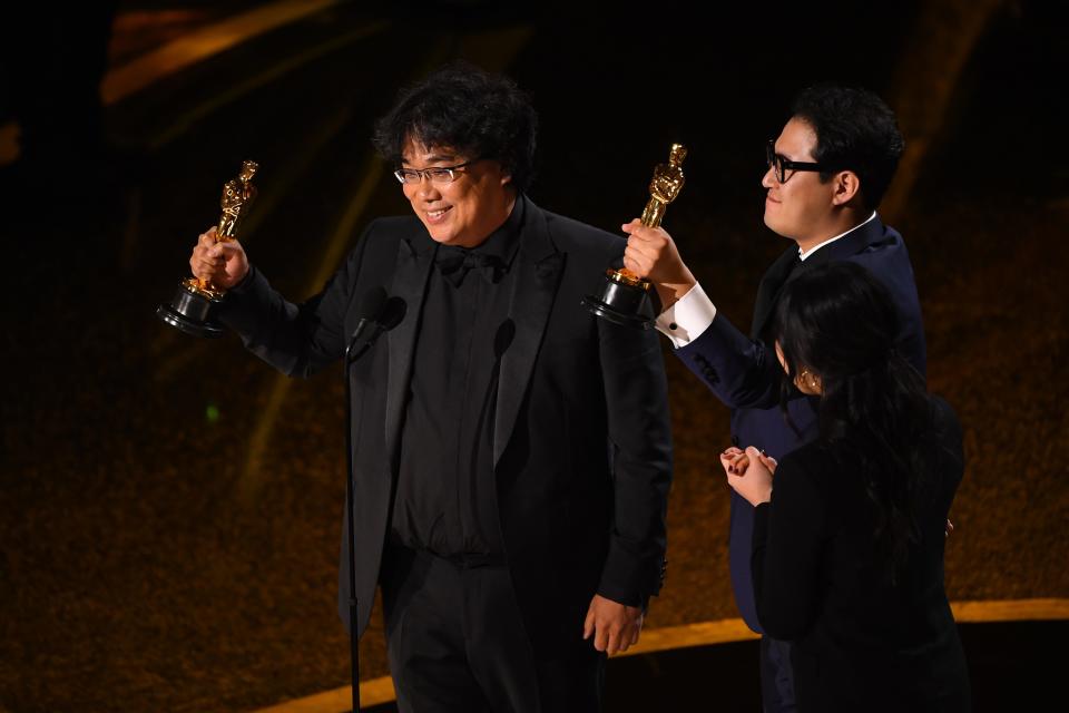 Bong Joon Ho (left)  and Han Jin Won accept the award for best original screenplay for "Parasite" during the 92nd Academy Awards at Dolby Theatre.