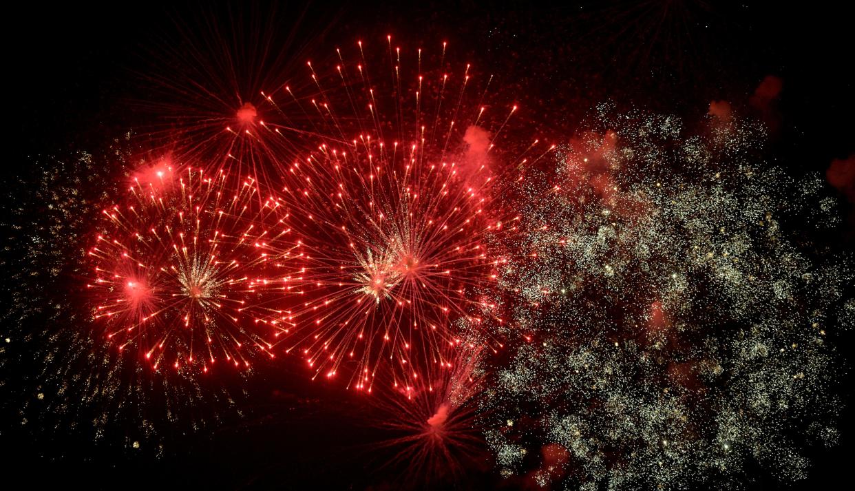 Fireworks light up the night sky over Peoria and East Peoria during the annual Red, White and Boom show Thursday, July 4, 2019 on the Illinois River. [MATT DAYHOFF/JOURNAL STAR]