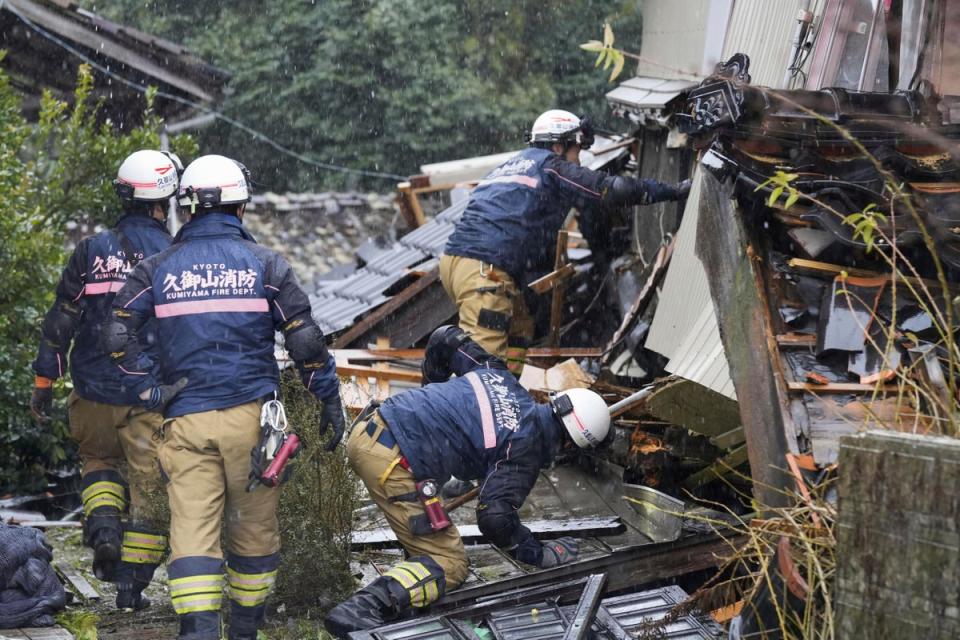 Firefighters conduct a search operation in Suzu, Ishikawa prefecture, Japan on Sunday (AP)