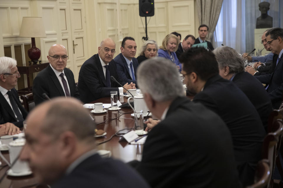 Greek foreign Minister Nikos Dendias, facing third left, takes part in a meeting with political party representatives on developments for the maritime boundary deal between Turkey and Libya in Athens, on Tuesday, Dec. 10, 2019. Greece has sent two letters to the United Nations explaining its objections to the deal and asking for the matter to be taken up by the U.N. Security Council, the government spokesman said Tuesday. (AP Photo/Petros Giannakouris)
