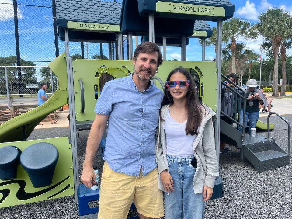 Rob Stickle, 52, with his 12-year-old daughter, Camille, watching the partial solar eclipse at Mirasol Park in Palm Beach Gardens on Monday, April 8, 2024.