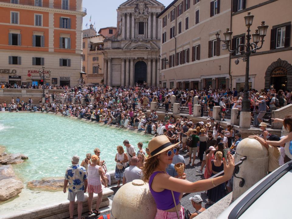 Tourists surround the Trevi fountain in Rome, Italy on July 17.