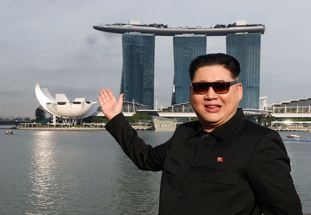 Howard, an Australian-Chinese impersonating North Korean leader Kim Jong Un, poses with the Marina Bay Sands hotel in the background in Singapore May 27, 2018. REUTERS/Edgar Su