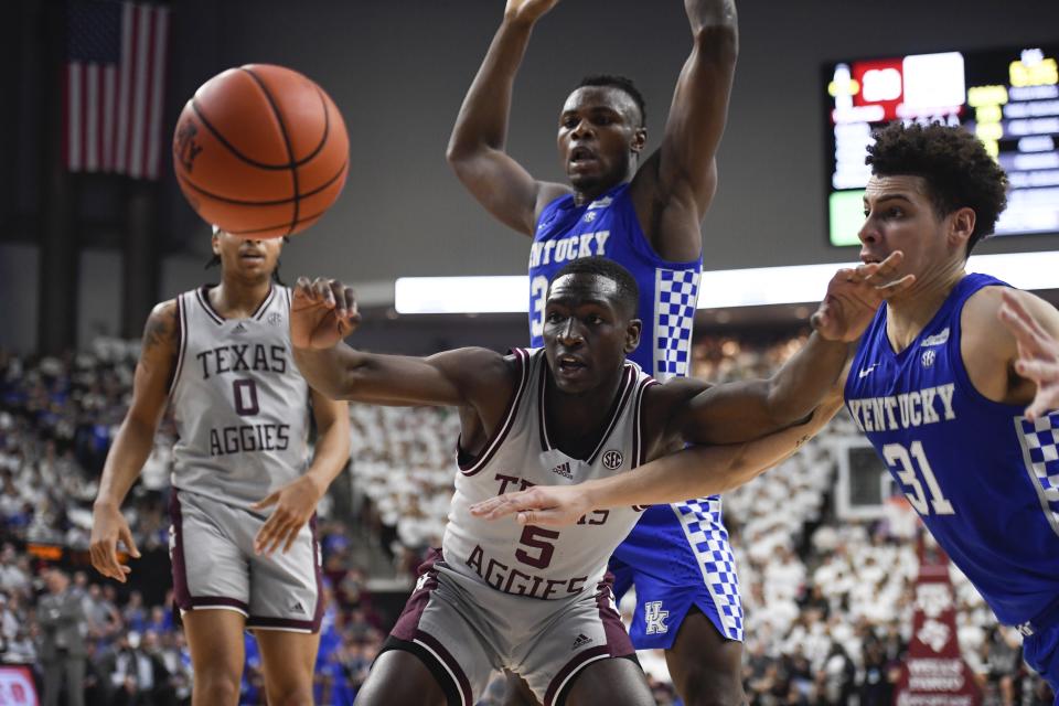 Texas A&M guard Hassan Diarra (5) and Kentucky guard Kellan Grady (31) chase the ball during the first half of an NCAA college basketball game Wednesday, Jan. 19, 2022, in College Station, Texas. (AP Photo/Justin Rex)