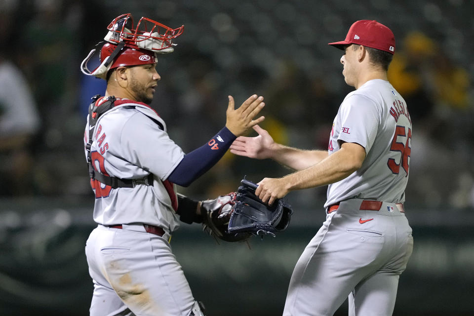 St. Louis Cardinals pitcher Ryan Helsley, right, is congratulated by catcher Willson Contreras after the team's victory against the Oakland Athletics in a baseball game in Oakland, Calif., Tuesday, April 16, 2024. (AP Photo/Tony Avelar)