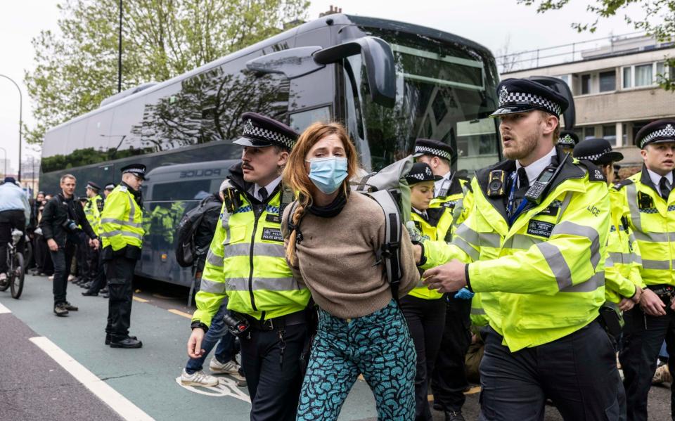 A protester is removed by police