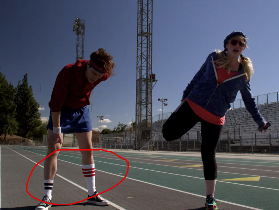 Dr. Reid wearing mismatching socks on a track field