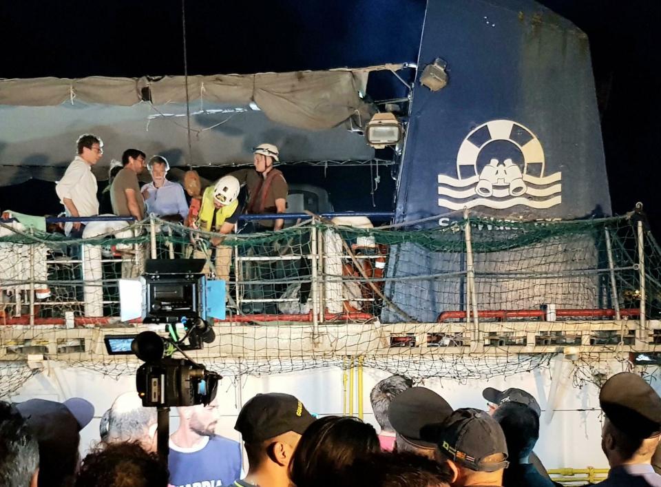 The Dutch-flagged Sea Watch 3 ship docks at Lampedusa island's harbor, Italy, early Saturday, June 29, 2019. Forty migrants have disembarked on a tiny Italian island after the captain of the German aid ship which rescued them docked without permission. Sea-Watch 3 rammed an Italian border police motorboat as it steered toward the pier on Lampedusa. Italian Interior Minister branded the captain, who was taken into custody, as an "outlaw" who put the lives of the police at risk. (Elio Desiderio/ANSA via AP)