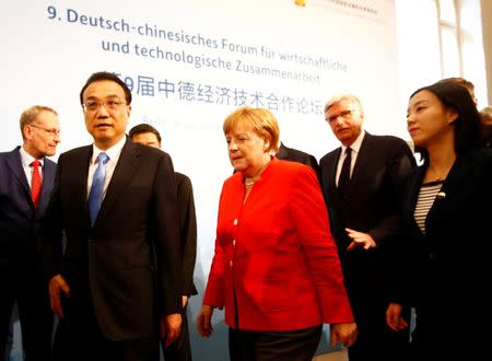 FILE PHOTO: German Chancellor Angela Merkel and Chinese Premier Li Keqiang arrive to the German-Chinese Forum for economic cooperation in Berlin, Germany July 9, 2018. REUTERS/Fabrizio Bensch/File Photo