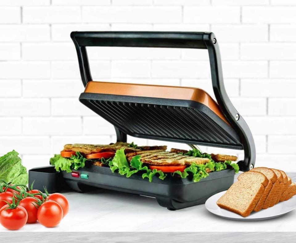 Get ready to <i>only</i> have ham and cheese sandwiches with crispy, golden brown ridges and gooey, thoroughly heated ingredients.<br /><br /><strong>Promising review:</strong> "It is quite compact but can easily do two panini sandwiches. Easy to clean. Cooks the paninis nicely. No temperature control, but I don&rsquo;t need it for most sandwiches. Great value for the price!" &mdash; <a href="https://amzn.to/3aiXcsH" target="_blank" rel="nofollow noopener noreferrer" data-skimlinks-tracking="5723569" data-vars-affiliate="Amazon" data-vars-href="https://www.amazon.com/gp/customer-reviews/R1M51B15CN3TMB?tag=bfjasmin-20&amp;ascsubtag=5723569%2C3%2C31%2Cmobile_web%2C0%2C0%2C0" data-vars-keywords="cleaning" data-vars-link-id="0" data-vars-price="" data-vars-retailers="Amazon">Amazon Customer</a><br /><br /><strong>Get it from Amazon for <a href="https://amzn.to/3dpel63" target="_blank" rel="noopener noreferrer">$28.99+</a> (available in three colors).</strong>