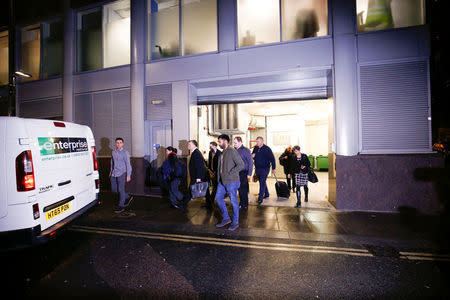 A van and a group of people leave the building which houses the offices of Cambridge Analytica as investigators from Britain's Information Commissioners Office entered, following the granting of a search warrant by a High Court judge, in London, Britain March 23, 2018. REUTERS/Henry Nicholls