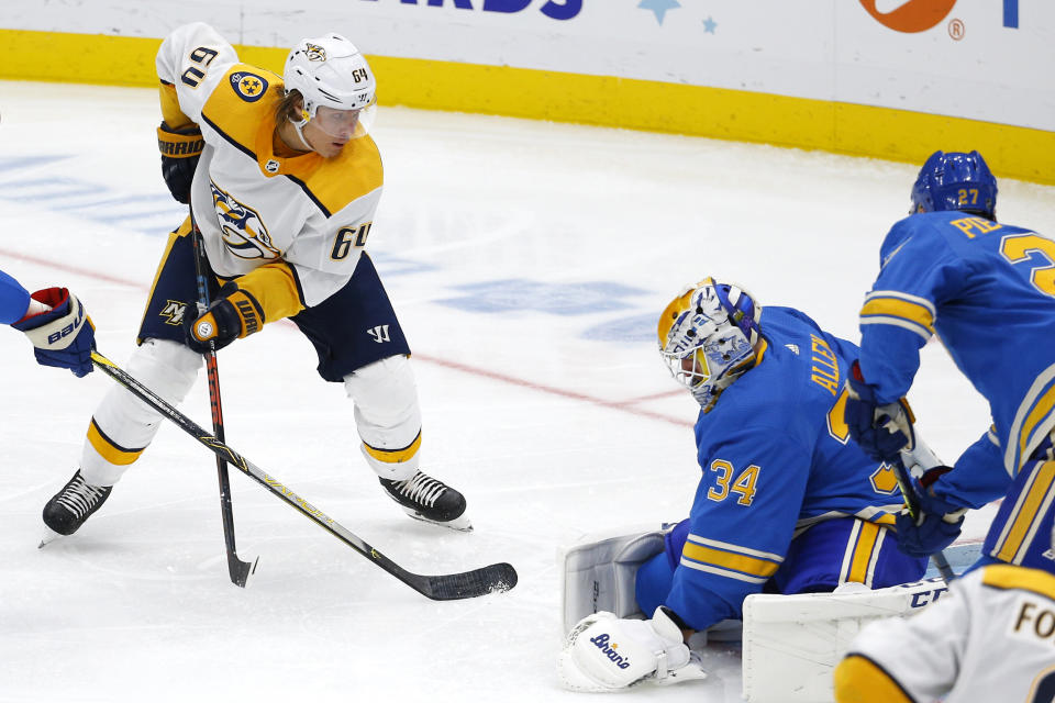 Nashville Predators' Mikael Granlund, top left, of Finland, watches his shot get past St. Louis Blues goaltender Jake Allen for the game winning goal during the third period of an NHL hockey game Saturday, Feb. 15, 2020, in St. Louis. (AP Photo/Billy Hurst)