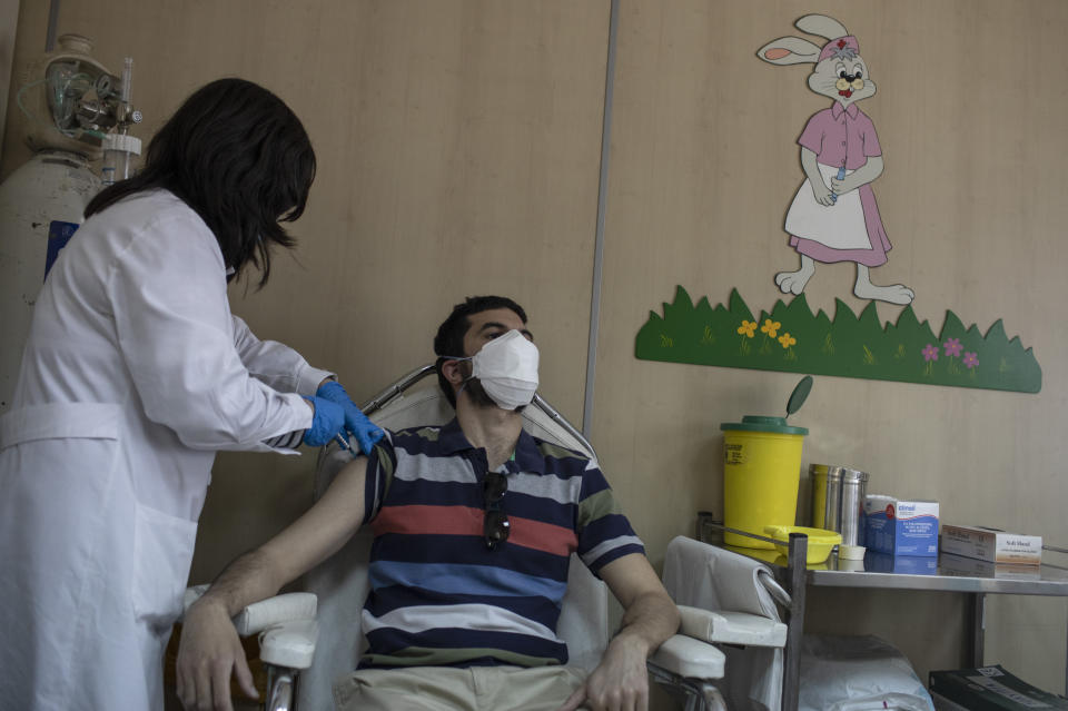 36 year-old Vasilis Tsipiras receives his first dose of the of the AstraZeneca COVID-19 vaccine, at a vaccination center in Piraeus, near Athens, Thursday, April 29, 2021. Greece’s health minister says any adult who wants to be vaccinated against COVID-19 will be able to do so by the end of June, as the country ramps up its vaccination drive. (AP Photo/Petros Giannakouris)