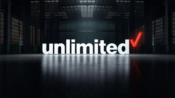 Verizon unlimited logo superimposed on a photo of an empty warehouse