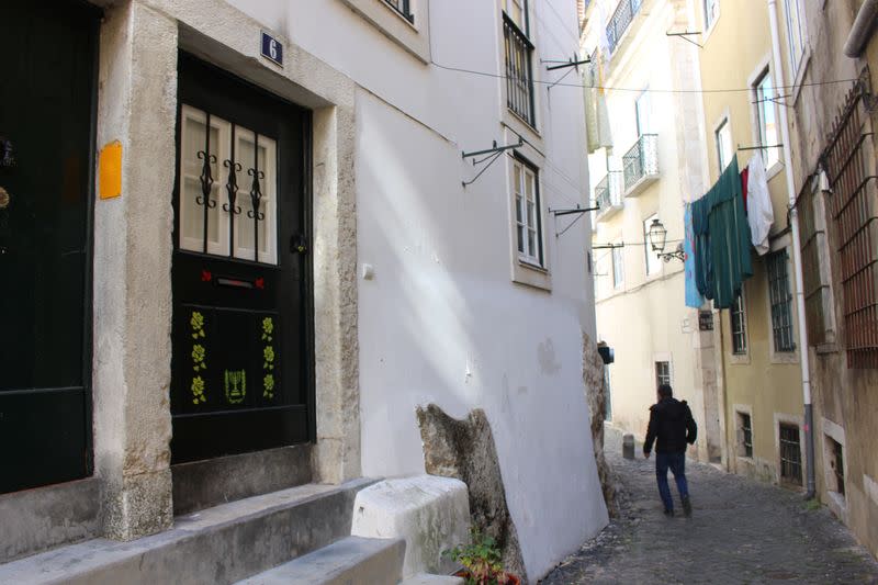 A man walks down an alley in the former Jewish quarter in one of Lisbons most historic neighbourhoods of Alfama