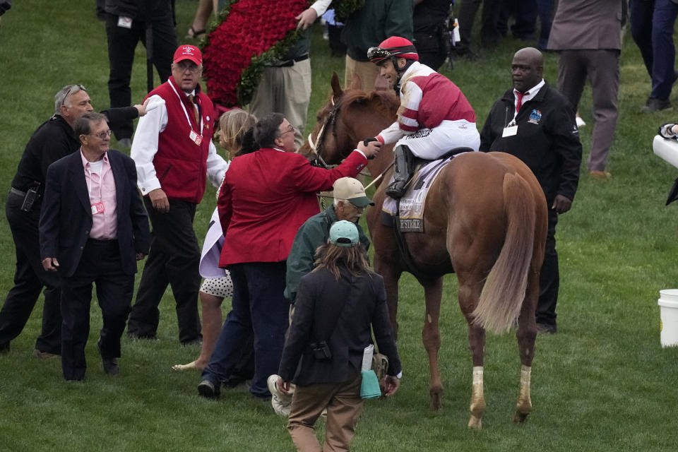 Jockey Sonny Leon is congratulated after riding Rich Strike to victory in the 148th running of the Kentucky Derby horse race at Churchill Downs Saturday, May 7, 2022, in Louisville, Ky. (AP Photo/Charlie Riedel)