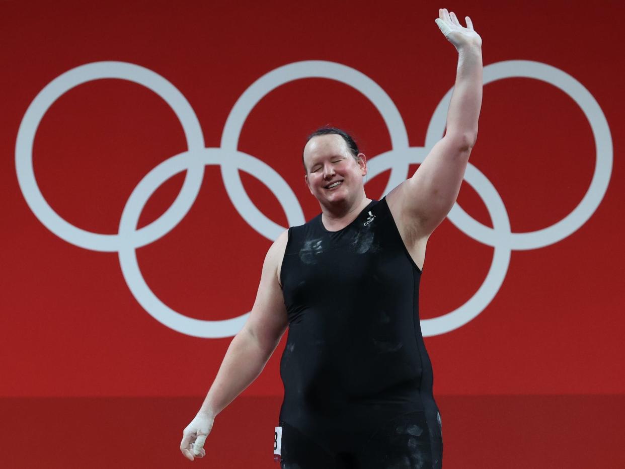 Laurel Hubbard, of New Zealand, waves during the weightlifting event at the Olympic Games in Tokyo.