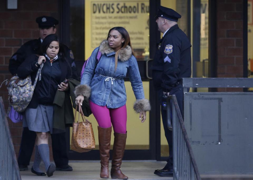 Students exit the Delaware Valley Charter School Friday, Jan. 17, 2014, in Philadelphia. Police say two students have been shot at a Philadelphia high school. (AP Photo/Matt Rourke)