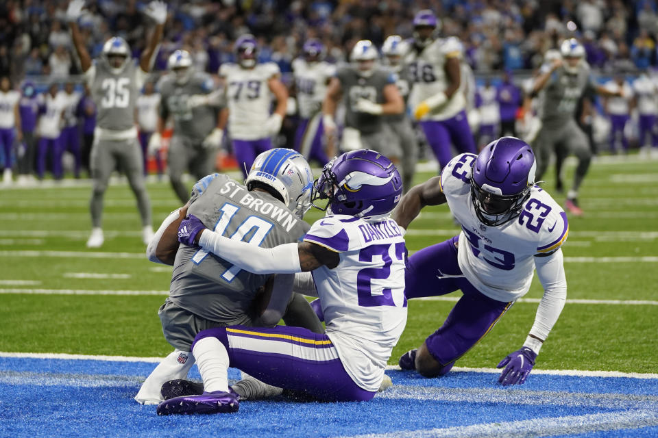 Detroit Lions wide receiver Amon-Ra St. Brown (14) catches a 11-yard pass for a touchdown in the last second sof play during the second half of an NFL football game against the Minnesota Vikings, Sunday, Dec. 5, 2021, in Detroit. (AP Photo/Paul Sancya)