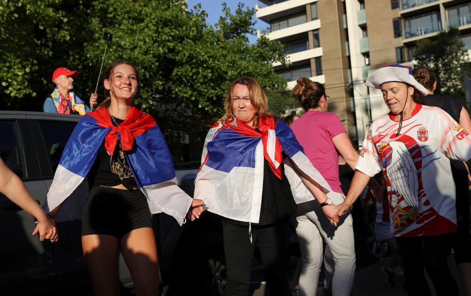 Supporters of Serbian tennis player Novak Djokovic rally outside the Park Hotel - REUTERS