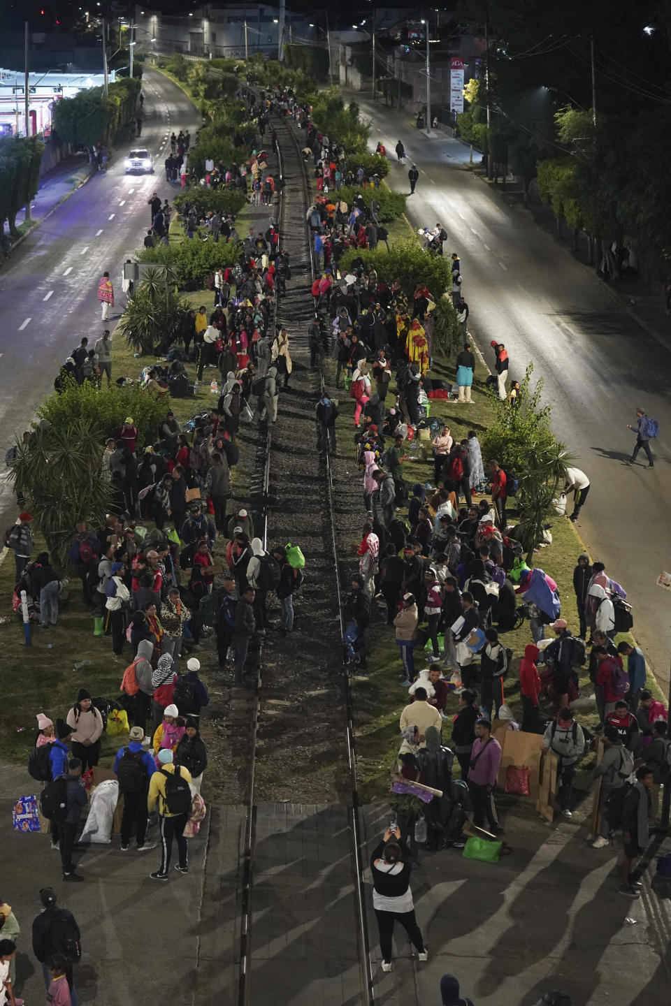 Migrants wait for a northbound freight train, in Irapuato, Mexico, Saturday, Sept. 23, 2023. (AP Photo/Marco Ugarte)