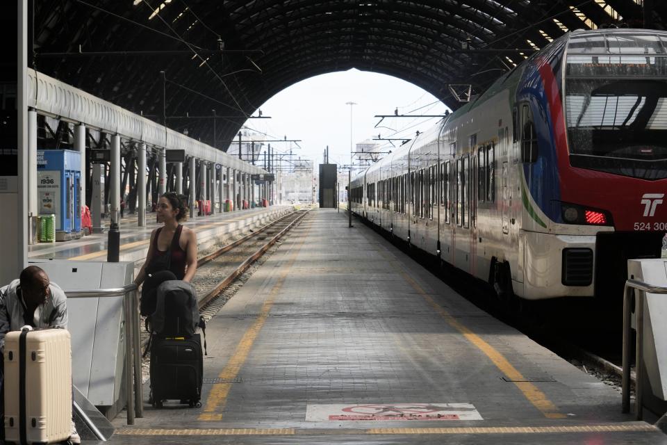 Passengers wait for a train at Milan central station during a national train strike, Thursday, July 13, 2023. Trenitalia and Italo train workers are on strike to demand better working conditions and training. in Milan, Italy, Thursday, July 13, 2023. (AP Photo/Luca Bruno)