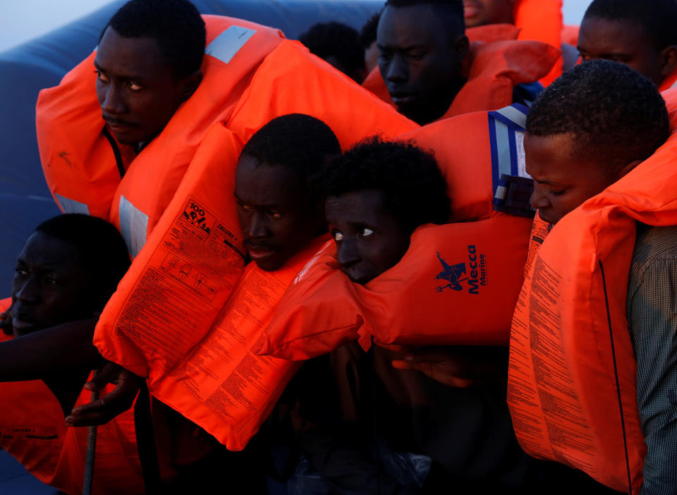 Migrants on board a rubber dinghy await rescue