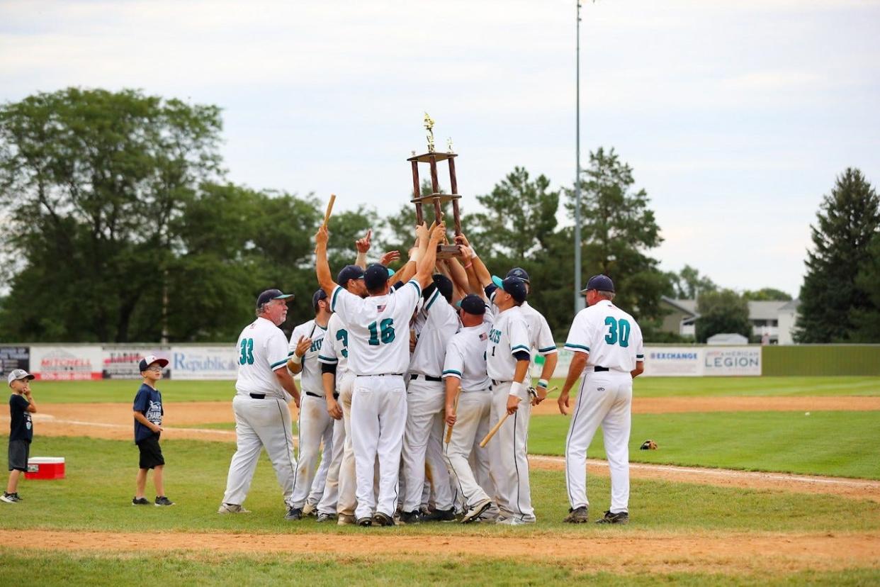 The Dell Rapids Mudcats celebrate the Class B amateur baseball state championship Sunday at Cadwell Park in Mitchell