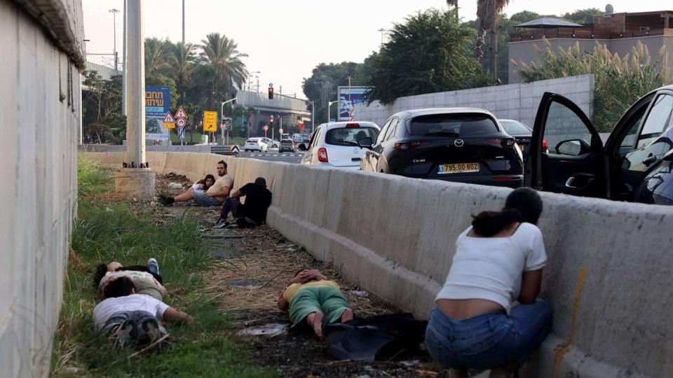 PHOTO: People leave their vehicles to take cover during a rocket attack from the Palestinian Gaza Strip along a main road in Tel Aviv on October 24, 2023. (Gil Cohen-magen/AFP via Getty Images)