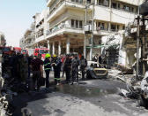 Iraqi security forces and firefighters gather at the site of car bomb attack near a government office in Karkh district in Baghdad, Iraq, May 30, 2017. REUTERS/Khalid al-Mousily