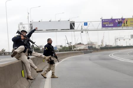 Federal police officers are seen at the Rio-Niteroi Bridge, where armed police surrounded a hijacked passenger bus in Rio de Janeiro