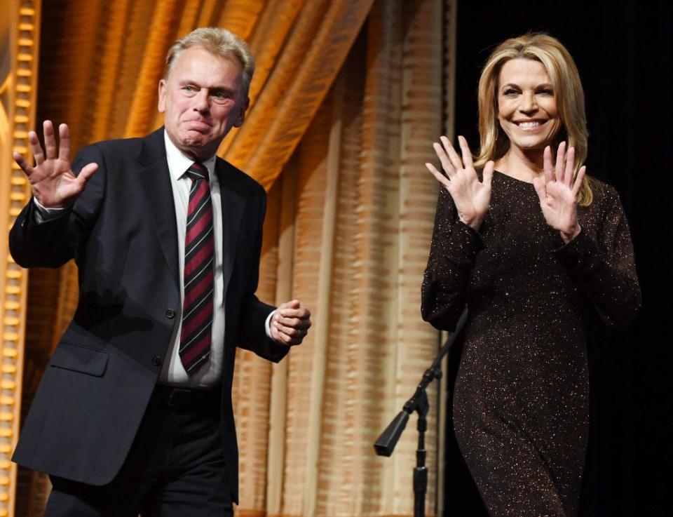 "Wheel of Fortune" host Pat Sajak (L) and hostess Vanna White walk onstage as they are inducted into the National Association of Broadcasters Broadcasting Hall of Fame during the NAB Achievement in Broadcasting Dinner at Encore Las Vegas on April 9, 2018, in Las Vegas.