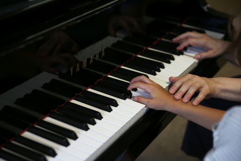 Stelios Kerasidis, 7-year-old pianist and composer, plays the piano during a lesson at the Athens Megaron Concert Hall in Athens