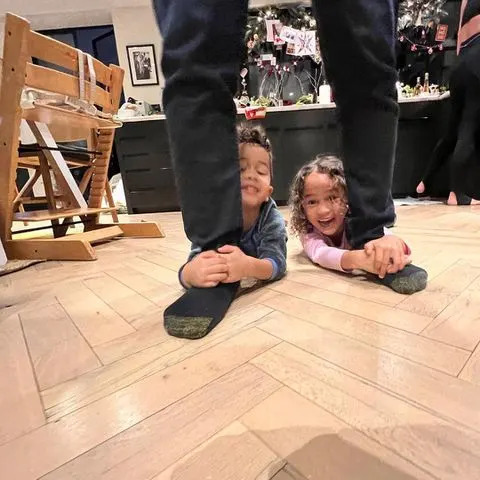 john legend/ instagram John Legend's kids, Luna and Miles, hold on to their dad's legs