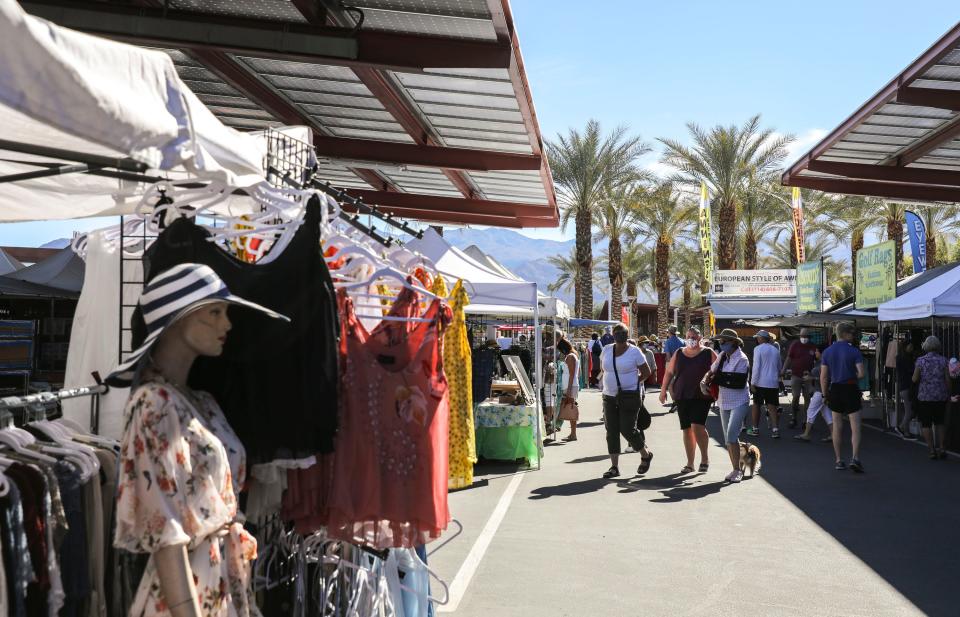 People wander between vendors during the College of the Desert Street Festival in Palm Desert, Calif., Saturday, Feb. 5, 2022. The fair still runs from 8 a.m. to 2 p.m. every Saturday and Sunday at COD.