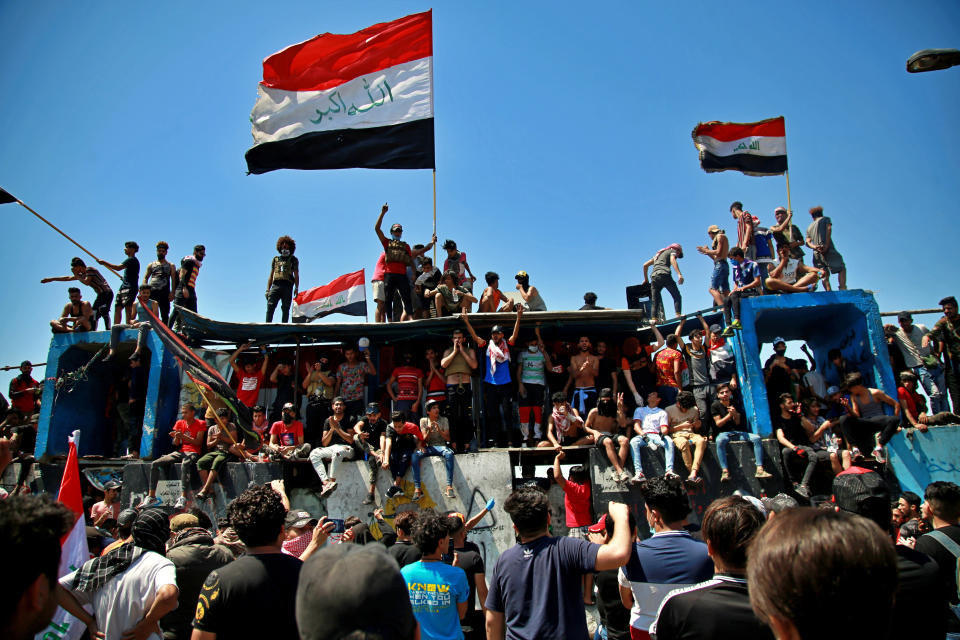 Anti-government protesters stage a sit-in on barriers set up by security forces to close the Jumhuriyah Bridge leading to the Green Zone government area, during ongoing protests in Baghdad, Iraq, Sunday, May 10, 2020. Protesters were back on the streets three days after Mustafa al-Kadhimi was appointed as Iraq's new prime minister. (AP Photo/Khalid Mohammed)