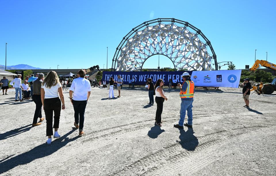 Guests walk around the property of the Hoberman Arch from the 2002 Olympics at the Salt Lake City International Airport on Tuesday, Aug. 29, 2023. | Scott G Winterton, Deseret News