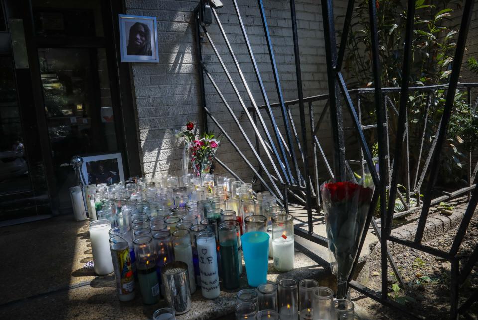 Flowers and candles form a memorial at the entrance of an apartment building for shooting victim Deshawn Reid, Monday, Aug. 17, 2020, in New York. President Donald Trump is again threatening to send federal agents to New York City if local authorities don't stop a surge of violence that has left seven people dead. Including Reid, 28, and more than 50 people shot since Friday. (AP Photo/Bebeto Matthews)