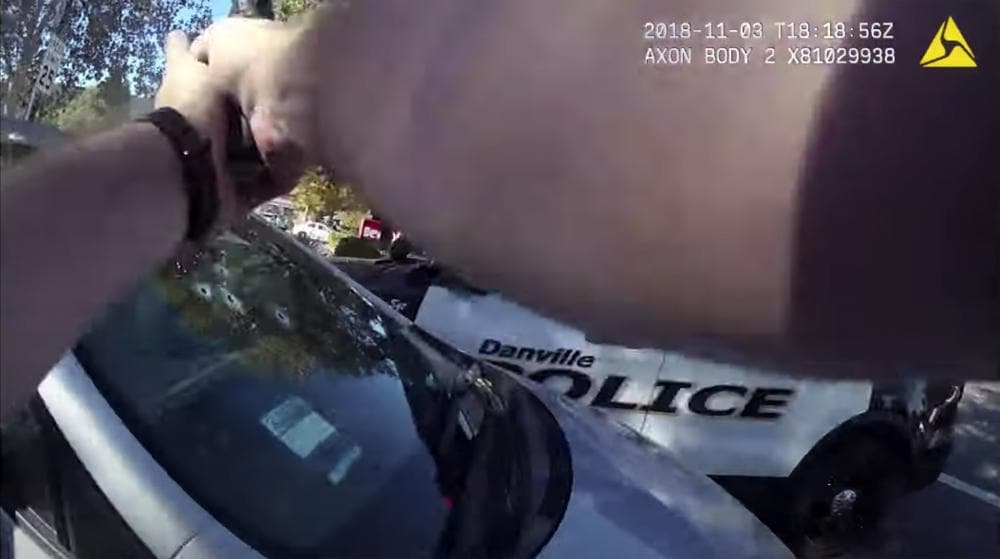 This image from body-worn camera video provided by the Contra Costa County Sheriff’s Office shows Danville Police Officer Andrew Hall with his gun pointed at a car driven by Laudemar Arboleda, Nov. 3, 2018, in Danville, Calif. (Contra Costa Sheriff via AP)