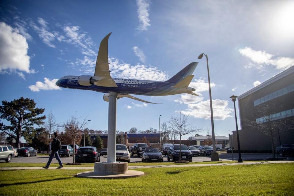 A student walks under a display celebrating the Aviation Sciences program at Elizabeth City State University.