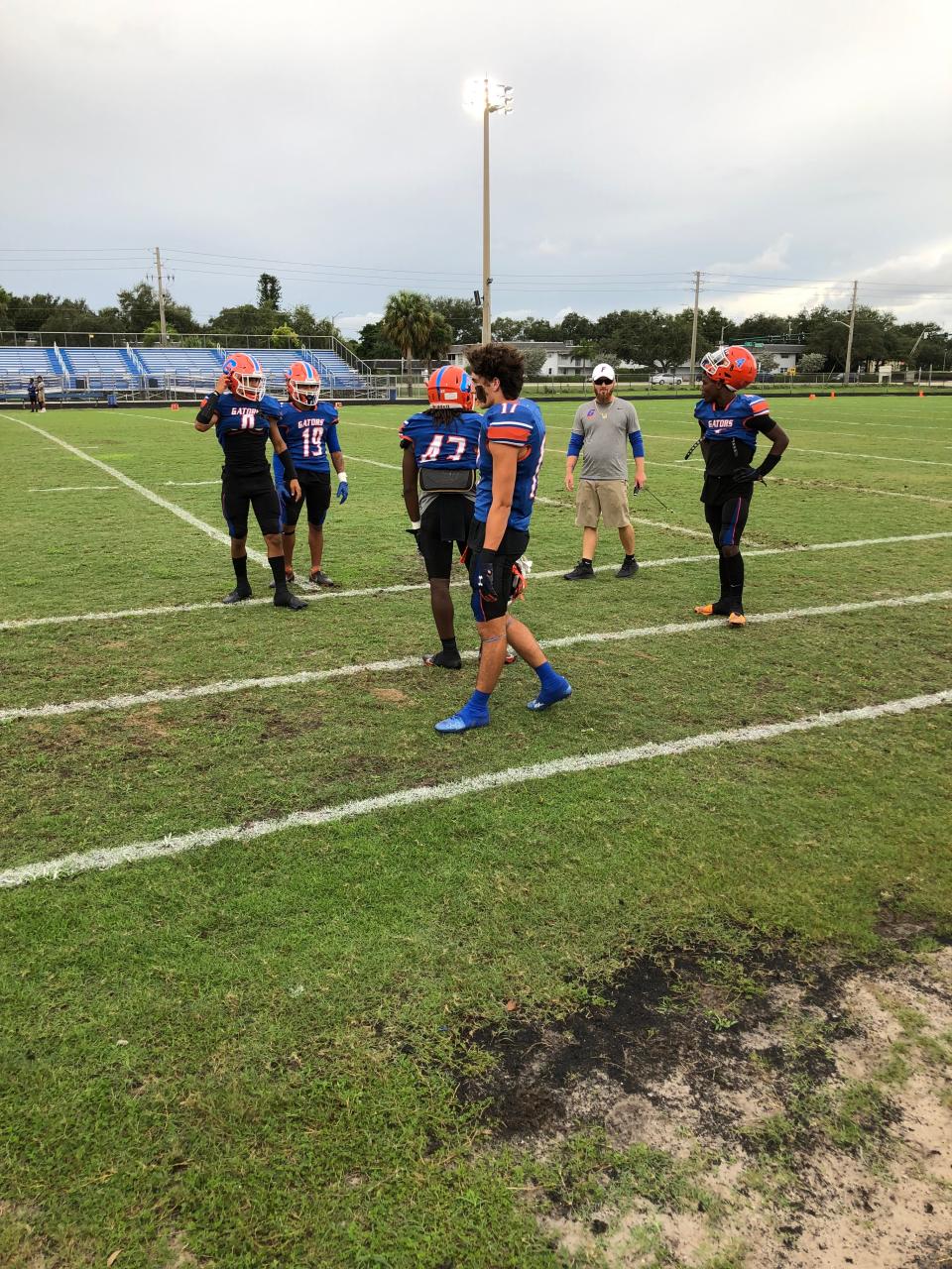 Palm Beach Gardens defensive backs coach Andrew Rice, second from right, works out his secondary men before the game.