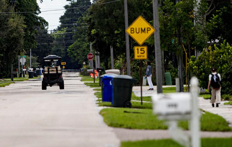 A person drives a golf cart along Cortez Avenue in Fort Myers on Friday, Sept. 9, 2022.  