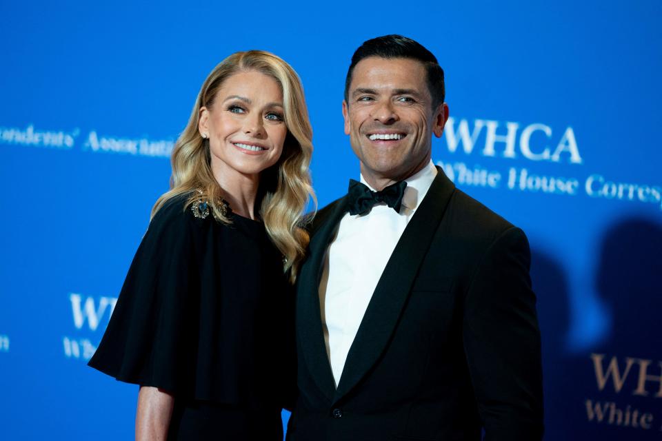 Kelly Ripa and Mark Consuelos smile on red carpet