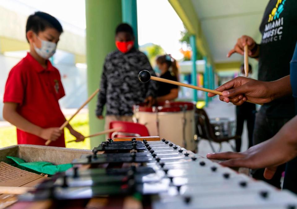 Students play percussion during a Miami Music Project practice session at Carol City Elementary in Miami Gardens.