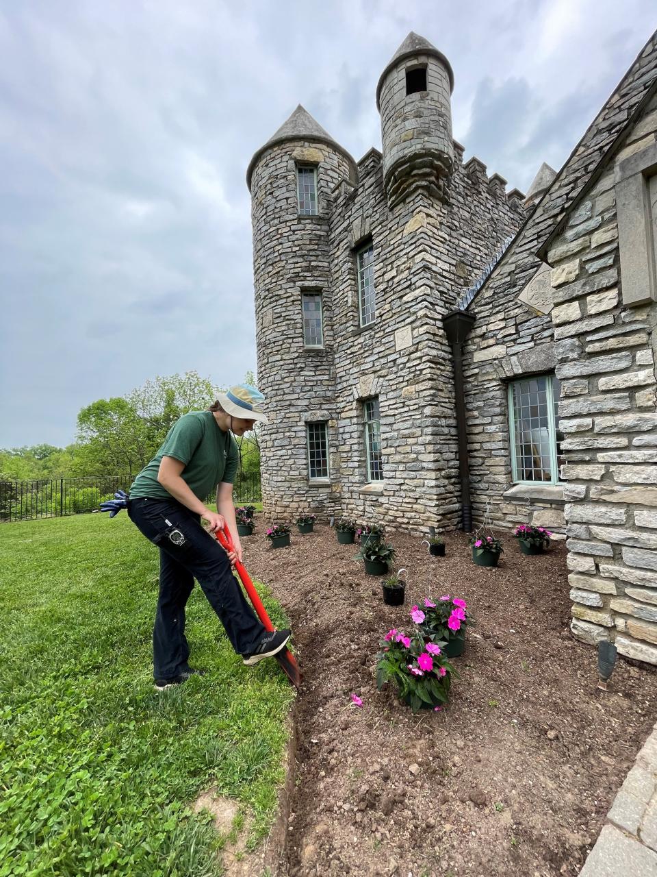 Yew Dell Botancial Gardens horticulture apprentice, Elaine Losekamp, puts a fresh edge on one of the Castle Garden planting beds.